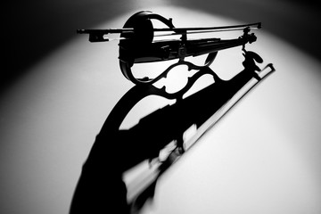 Electric violin stands on a white background