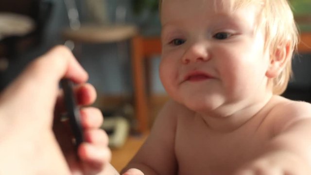 closeup portrait cute caucasian baby boy having fun at home looking at camera beautiful blue eyes chubby cheeks beautiful summer day sun light on background parenting happy family concept healthcare