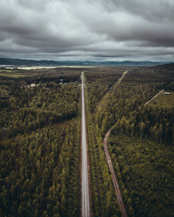 Fototapeta na wymiar Railway track in forest seen from the sky, northern Finland
