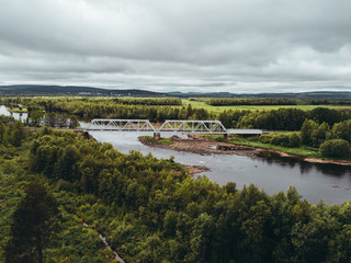 Obraz premium Steel railroad bridge over river in northern Finland