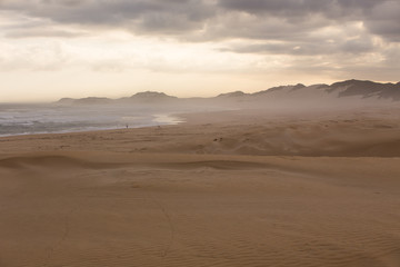 Fototapeta na wymiar Sand Dunes in Kenton and a Fisherman