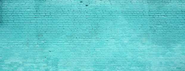 The texture of the brick wall of many rows of bricks painted in cyan color