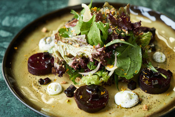 Beet Salad with Goat Cheese, Candied Walnuts, Spring Greens, and Herbs. Healthy diet  and Vegetarian food