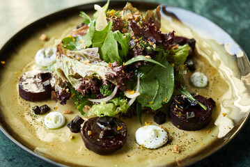 Beet Salad with Goat Cheese, Candied Walnuts, Spring Greens, and Herbs. Healthy diet  and Vegetarian food