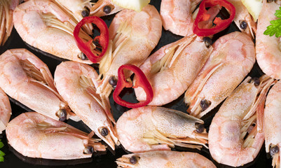 shrimp with red pepper in a black plate