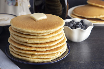 Stack of Freshly Made American Style Pancakes with Metling Butter