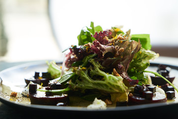 Beet Salad with Goat Cheese, Candied Walnuts, Spring Greens, and Herbs. Healthy diet  and Vegetarian food