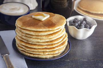 Stack of Freshly Made American Style Pancakes with Metling Butter