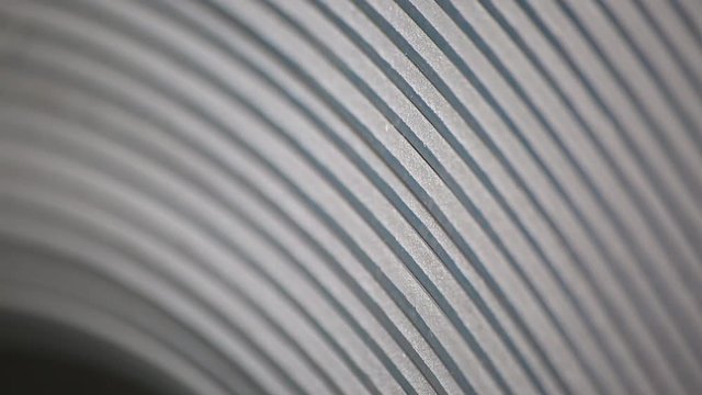 roll tin close-up. lines as a hemisphere. create profiles. rolls of galvanized steel. rolls of sheet metal. steel roll in section
