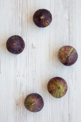 Fresh figs on white wooden table, from above. Overhead, flat lay, top view.