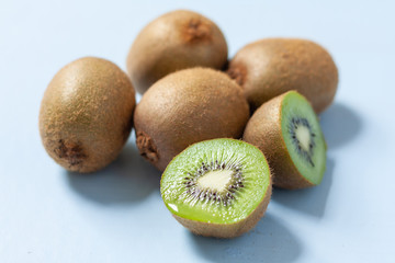 Fresh kiwi fruits on a pale blue background