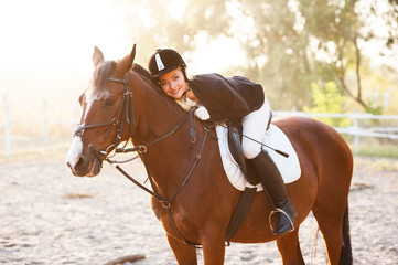 A beautiful girl rider walks with a horse. Horse theme
