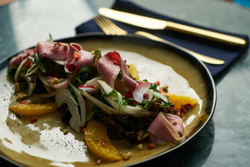 Healthy diet salad with Smoked duck breast, Candied Walnuts, Spring Greens, Orange and Herbs. Smoked duck breast with fresh vegetable salad