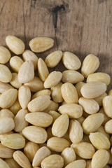 peeled almonds on wooden surface