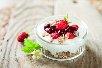 Healthy snack - yogurt with wild strawberry fruits
