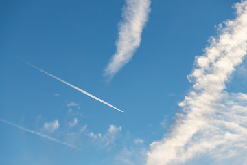 Airplane flying in the blue sky. Blue sky and clouds background
