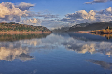serene day on the river with just a few clouds at the edges
