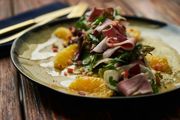 Vegetable salad with Smoked duck breast. Healthy fresh vegetable salad with smoked duck, Candied Walnuts, Spring Greens, Orange and Herbs