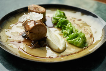 Chicken galantine, mushroom fricassee, young cabbage and sauce. chicken sausage with baked green cabbage. Healthy diet food concept.