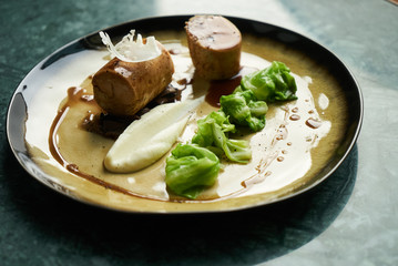 Chicken galantine, mushroom fricassee, young cabbage and sauce. chicken sausage with baked green cabbage. Healthy diet food concept.
