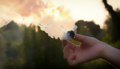 Smoke swirl, emits smoke in the man's hand