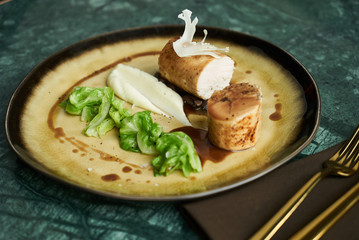 Chicken galantine, mushroom fricassee, young cabbage and sauce. chicken sausage with baked green cabbage. Healthy diet food concept.