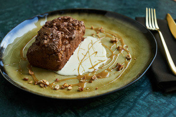 Chocolate dessert fondant with a liquid and pistachio ice cream, close-up