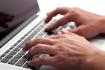Closeup of a Man Typing on a Laptop