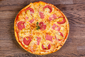 Pizza with ham and sausages