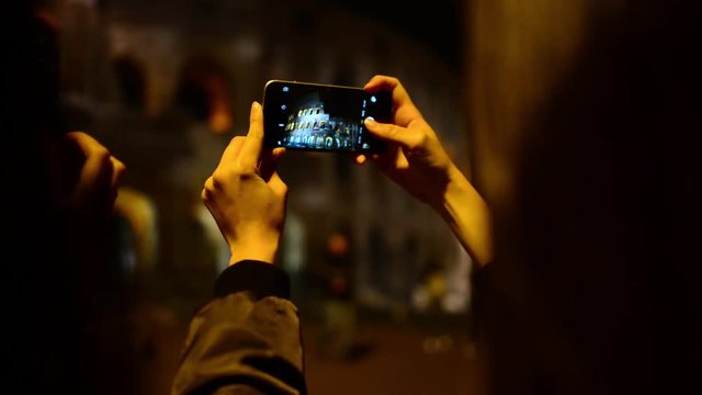 Coliseum at Night. Girls Korean, Japanese, Chinese browse photos at camera