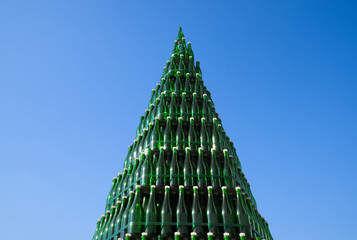 Christmas tree of bottles of champagne. Creative from bottles. Empty bottles of champagne.