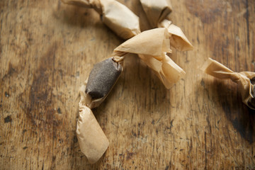 Holiday chocolate candies individually wrapped on wood cutting board