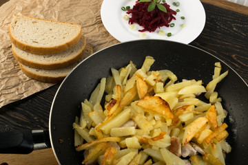 Homemade Roasted Potato in a Frying Pan on Rustic Background