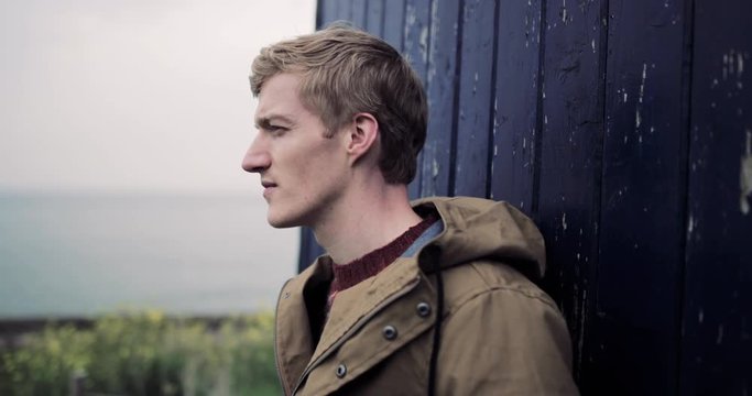 Millennial male relaxing in countryside