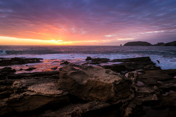 Stone cliff and beautiful sunset with cloudy sky