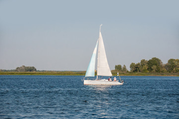 Obraz premium Container ship in export and import business and logistics. Shipping cargo to harbor by crane. Water transport International. Aerial view