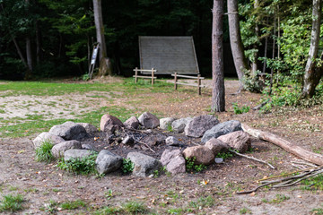 Fototapeta premium A place for a bonfire in the forest camp. Prepared a safe place for a bonfire in the forest.