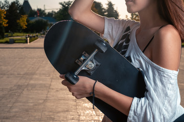 Girl with skateboard side view, copyspace © mettus