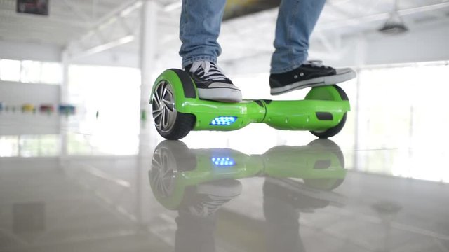 Man acrobat balancing motorized scooter - shows tricks