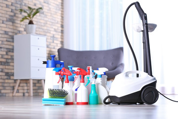 Vacuum cleaner and detergents on floor indoors