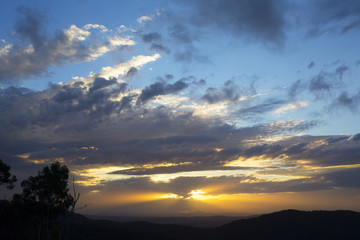 Fototapeta na wymiar Beautiful sun set and clouds over the mountain range