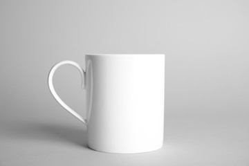 Ceramic cup on light background. Mock up for design