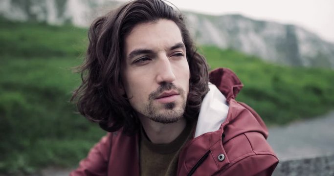 Millennial male taking a break on a hike
