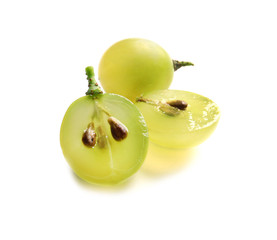 Cut and whole fresh ripe juicy grapes with seeds on white background