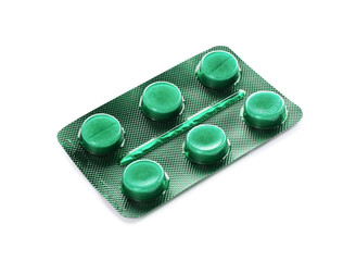 Pills in blister pack on white background. Medical treatment