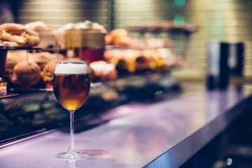 Glass of fresh beer on a bar counter