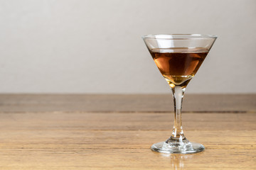 Whiskey or bourbon or mixed drink, neat, on a rustic, old, wood table