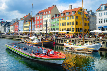 Touristic boat cruising by Nyhavn - obrazy, fototapety, plakaty