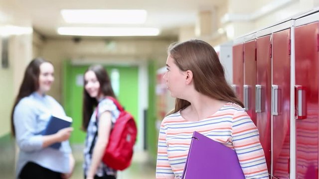 Unhappy Female High School Student Talked About By Students In Corridor