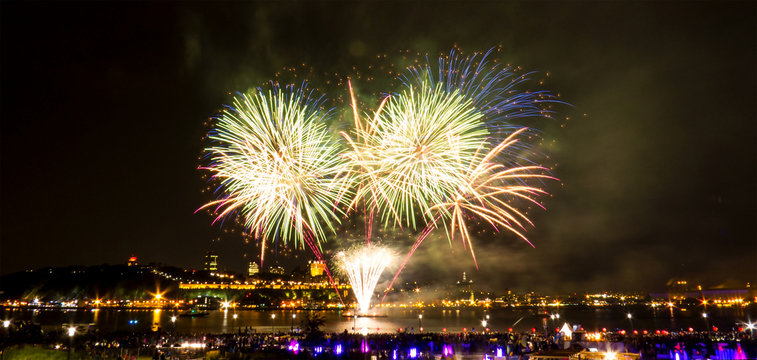 Bright fireworks over the Saint-Lawrence River near Quebec City during a Canadian summer festival.